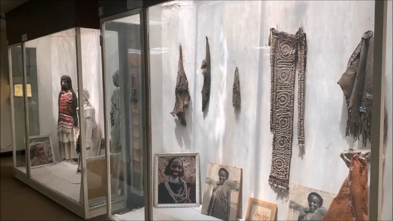 Traditional clothes and old photos in the museum’s textile archive display