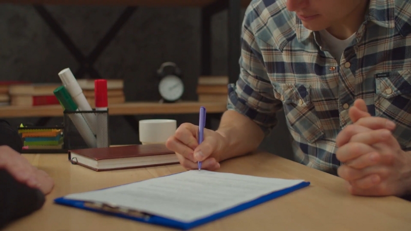 A buyer signs property documents, highlighting key risks in Ethiopia’s real estate market